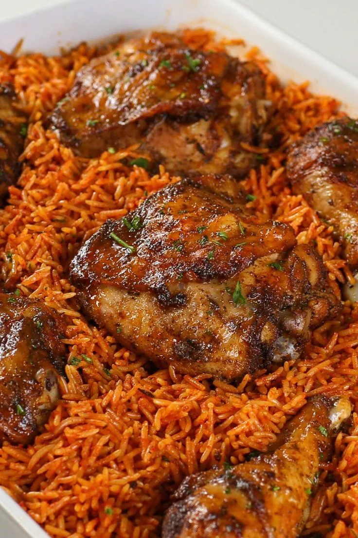 A dish of jollof rice with browned chicken